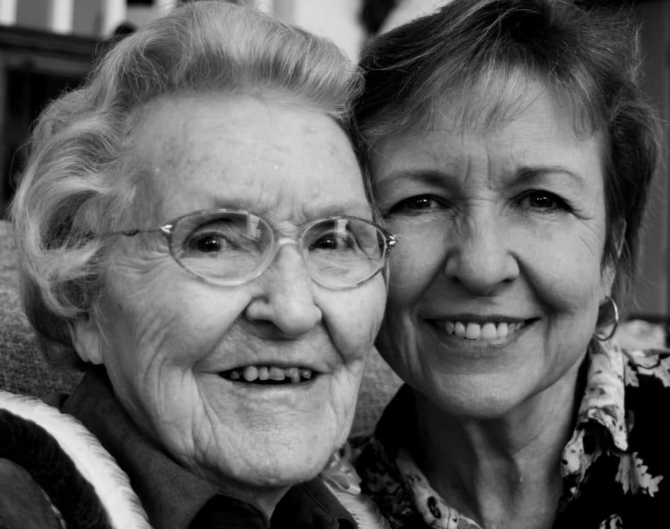 A portrait of an elderly mother and her adult daughter together